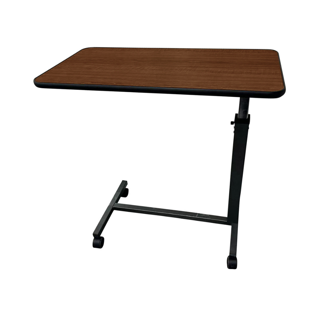 The Proactive Medical Protekt Non-Tilt Overbed Table features an adjustable, rectangular brown wooden top and black metal legs with wheels, shown against a white background.